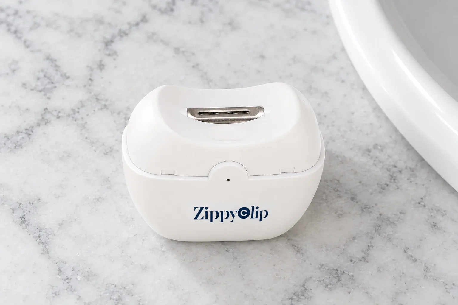The ZippyClip seen from above, the recessed arc blade inside the opening on top
