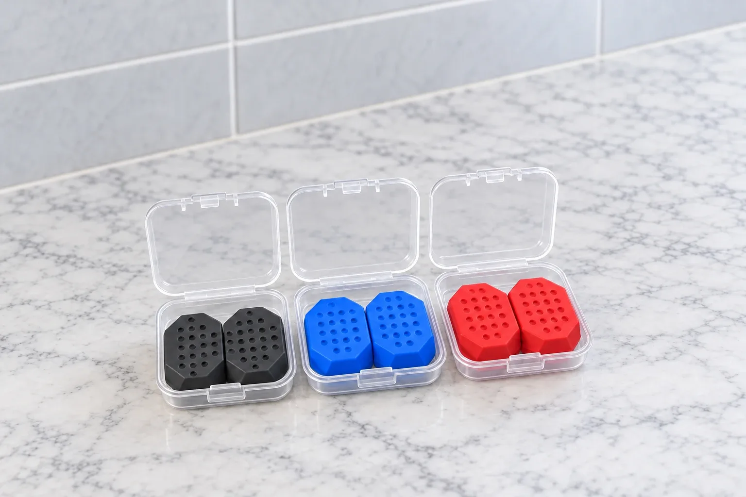 The JawCore case open with three levels of bite pieces inside on a marble counter